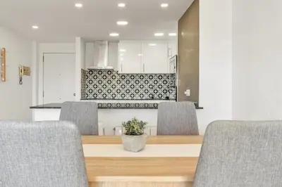 a dining room with a table and chairs at Sea View Penthouse in Vilanova i la Geltrú