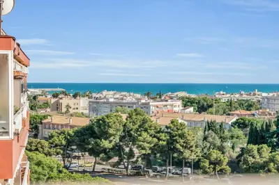a view of a city with the ocean in the background at Sea View Penthouse in Vilanova i la Geltrú