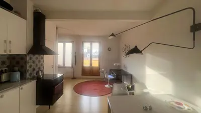 a kitchen with two sinks and a room with a window at Atico Central con Terraza in Barcelona