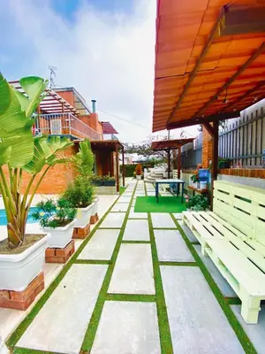 a patio with benches and plants on a building at Vila Peña Private Apartment with Shared Pool & Gardens in Cubelles