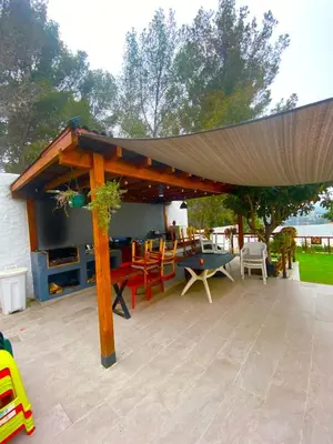 a pavilion with a table and chairs on a patio at Vila Peña Private Apartment with Shared Pool & Gardens in Cubelles