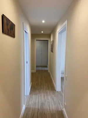 a hallway of a home with wood floors at RIUS33 - Huge & Spacious Apartment in Montjuic in Barcelona