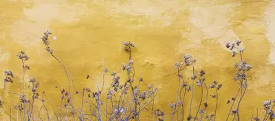 a painting of purple flowers on a yellow wall at RIUS33 - Huge & Spacious Apartment in Montjuic in Barcelona