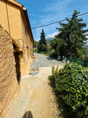 an image of a building with a path next to it at Casa Rural CAL PAGÉS Montseny in Montseny