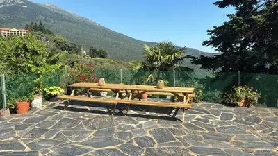 a wooden bench sitting on top of a stone patio at Casa Rural CAL PAGÉS Montseny in Montseny