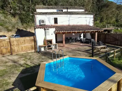 a pool in the backyard of a house at Casa Rural Can Ricós - El Mirador del Montseny in Vallgorguina