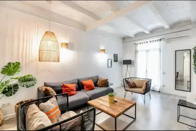 a living room with a couch and a table at Stylish apartment in Plaça Espanya in Barcelona