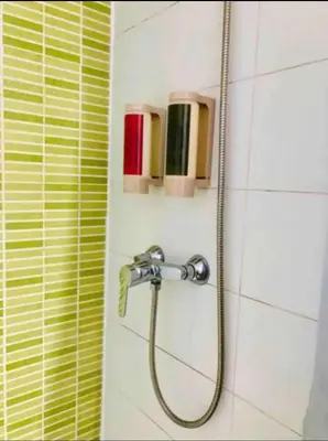a shower with a hose in a bathroom at Stylish apartment in Plaça Espanya in Barcelona
