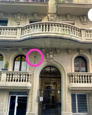 a building with a large door with a pink circle at Stylish apartment in Plaça Espanya in Barcelona