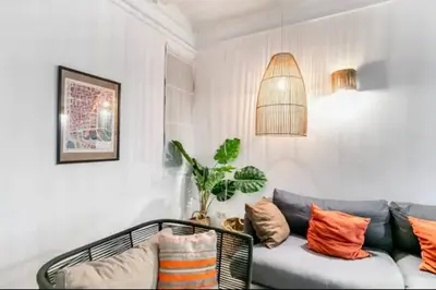 a living room with a couch and a potted plant at Stylish apartment in Plaça Espanya in Barcelona