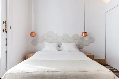a bedroom with a white bed with two lamps at La Casa de Antonio Boutique Rooms in Barcelona
