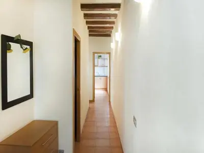 a hallway with white walls and a mirror on a wall at Luminoso apartamento 1 habitación cerca de Las Ramblas, hasta 4 pers, cocina equipada. - ES-341-6 in Barcelona