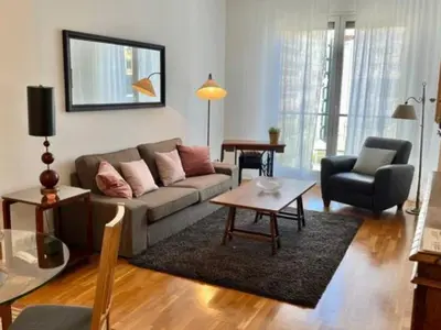 a living room with a couch and a table at Apartamento con 2 Dormitorios, Elegante y Céntrico en Rambla Catalunya - ES-341-2 in Barcelona