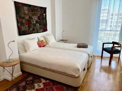 a bedroom with a large bed with a painting on the wall at Apartamento con 2 Dormitorios, Elegante y Céntrico en Rambla Catalunya - ES-341-2 in Barcelona