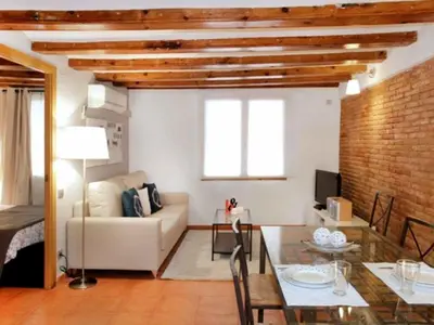 a living room with a couch and a table at Apartamento Céntrico en Edificio Histórico con Encanto para Familias, Hasta 5 Personas - ES-341-1 in Barcelona