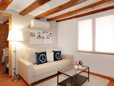 a living room with a couch and a table at Apartamento Céntrico en Edificio Histórico con Encanto para Familias, Hasta 5 Personas - ES-341-1 in Barcelona