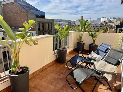 a balcony with chairs and plants on a roof at Apartamento con terraza privada y Wifi en el corazón de Barcelona - ES-341-5 in Barcelona