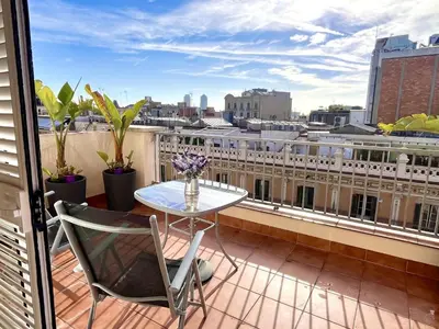 a balcony with a table and a view of a city at Apartamento con terraza privada y Wifi en el corazón de Barcelona - ES-341-5 in Barcelona