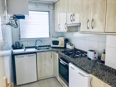 a small kitchen with a sink and a microwave at Apartamento con terraza privada y Wifi en el corazón de Barcelona - ES-341-5 in Barcelona