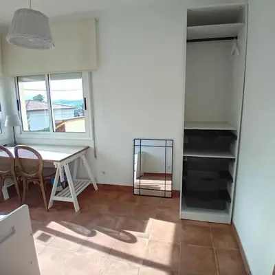 a dining room with a table and a table and chairs at Esplendida casa en Valldoreix in Sant Cugat del Vallès