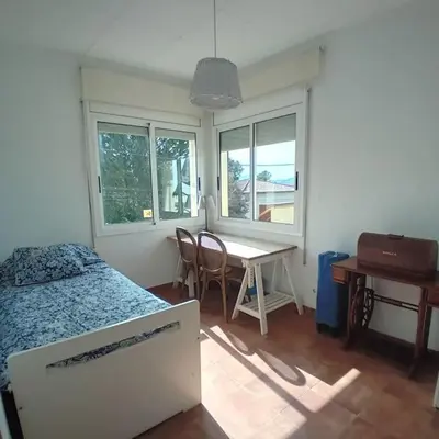 a bedroom with a bed and a table and a desk at Esplendida casa en Valldoreix in Sant Cugat del Vallès
