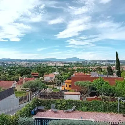 a view of a city from a building with benches at Esplendida casa en Valldoreix in Sant Cugat del Vallès