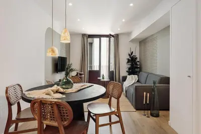 a patio with a couch and a table and chairs at Eboli - 3 bedrooms, balcony and terrace in Ciutat Vella in Barcelona
