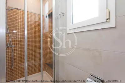 a shower with a glass door in a bathroom at Wonderful apartment in Barcelona