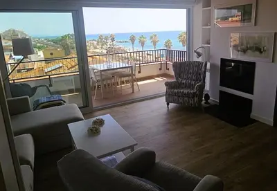 a living room with a couch and chairs and a balcony at Apartamento Bonavista in Vilassar de Mar