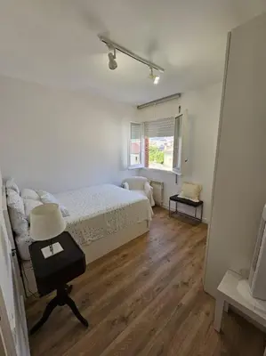a bedroom with a bed and a table with a lamp at Apartamento Bonavista in Vilassar de Mar