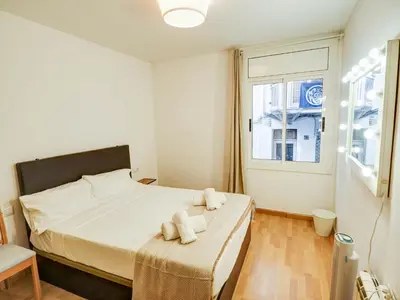 a bedroom with a bed with two towels on it at Bambino apartment by Hello Homes Sitges in Sitges