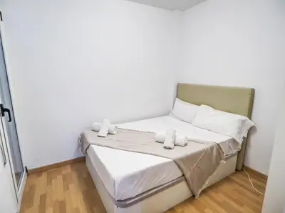 a small bedroom with a bed with towels on it at Bambino apartment by Hello Homes Sitges in Sitges