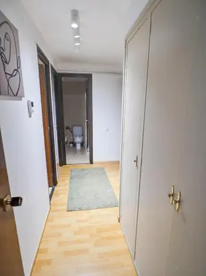 an empty hallway with a door and a rug at Bambino apartment by Hello Homes Sitges in Sitges