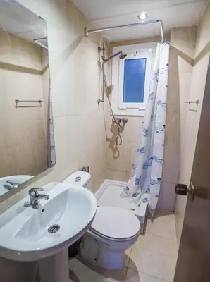 a bathroom with a sink and a toilet and a window at Bambino apartment by Hello Homes Sitges in Sitges
