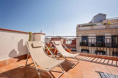 a group of chairs sitting on a roof at Sweett - Atic Gracia in Barcelona