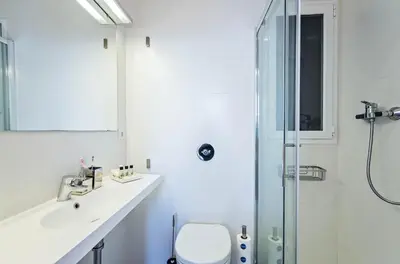 a bathroom with a toilet and a glass shower at Sweett - Atic Gracia in Barcelona