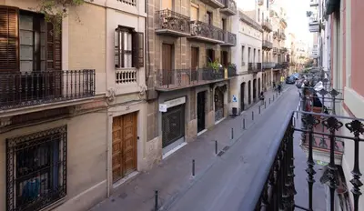 an empty street in a city with buildings at Stay U-nique Apartment Astúries in Barcelona