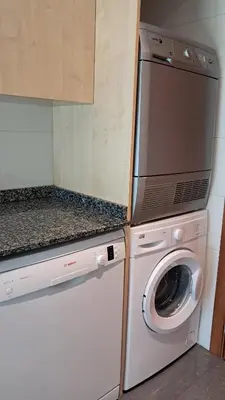 a kitchen with a washing machine and a washer at Modern apartment, with parking, close to the beach!! in Sant Adria de Besos