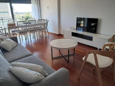 a living room with a couch and a table at Modern apartment, with parking, close to the beach!! in Sant Adria de Besos