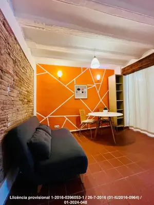 a living room with a couch and a table at Encanto Gótico Histórico Cerca de Las Ramblas in Barcelona