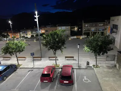three cars parked in a parking lot at night at DUPLEX LUMINOSO Y TRANQUILo in El Pont de Vilomara