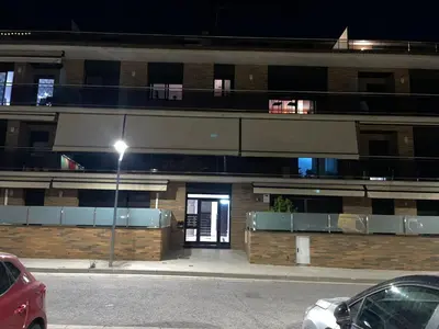 a building with a door on a street at night at DUPLEX LUMINOSO Y TRANQUILo in El Pont de Vilomara