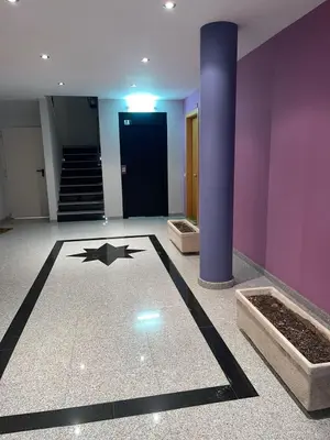 a lobby with a black star on the floor of a building at DUPLEX LUMINOSO Y TRANQUILo in El Pont de Vilomara