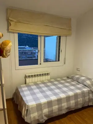 a bedroom with a bed and a window at DUPLEX LUMINOSO Y TRANQUILo in El Pont de Vilomara