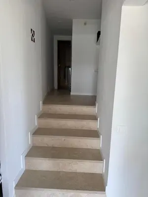 a stairway with white walls and a hallway at CASA CON JARDIN, SAUNA, PISCINA PRIVADA y NATURALEZA CERCA DE BARCELONA in Pallejá