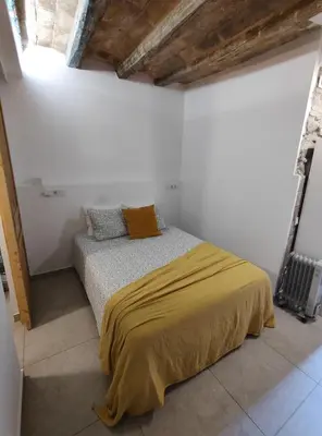 a bedroom with a bed in a white room at ANTIC Manresa 1 in Manresa