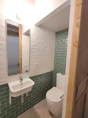 a bathroom with a white toilet and a sink at ANTIC Manresa 1 in Manresa