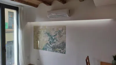a room with a ceiling fan and a painting on the wall at ANTIC Manresa 1 in Manresa