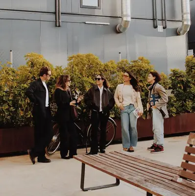 a group of women standing next to a bench at Residencia & Coliving para Postgrads in Barcelona