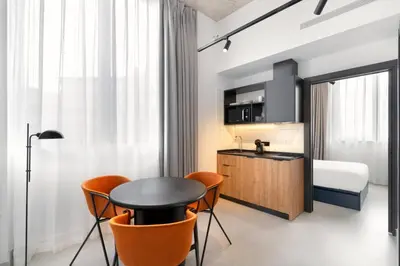 a room with a table and chairs and a bedroom at Residencia & Coliving para Postgrads in Barcelona